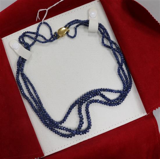 An Italian triple strand facetted sapphire bead necklace with 18ct gold clasp, approx. 49cm.